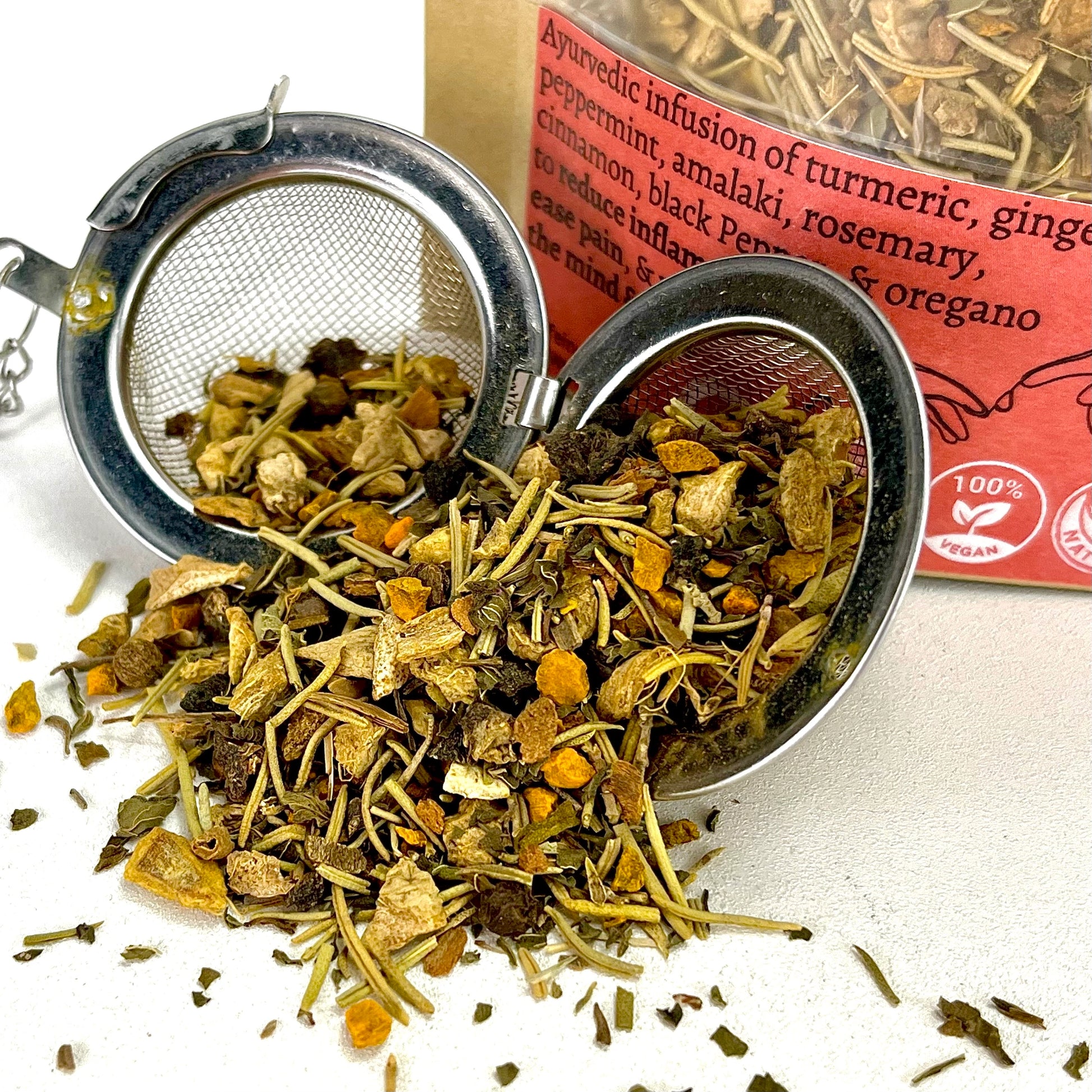 Anti-inflammatory loose leaf tea raw ingredients in an open tea ball strainer.