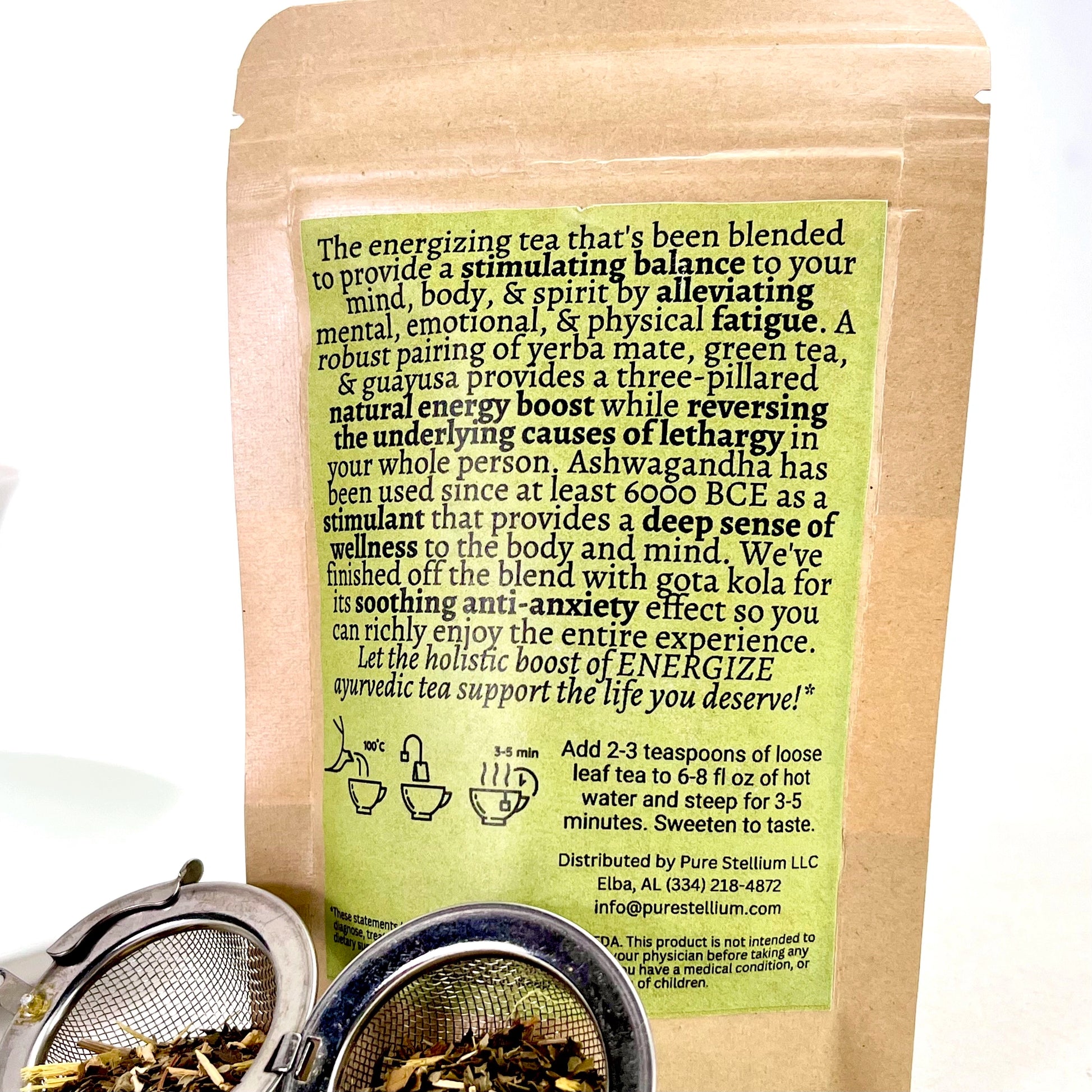 The package of Elemental Life Product's Energize loose leaf tea blend with raw ingredients in an open tea ball