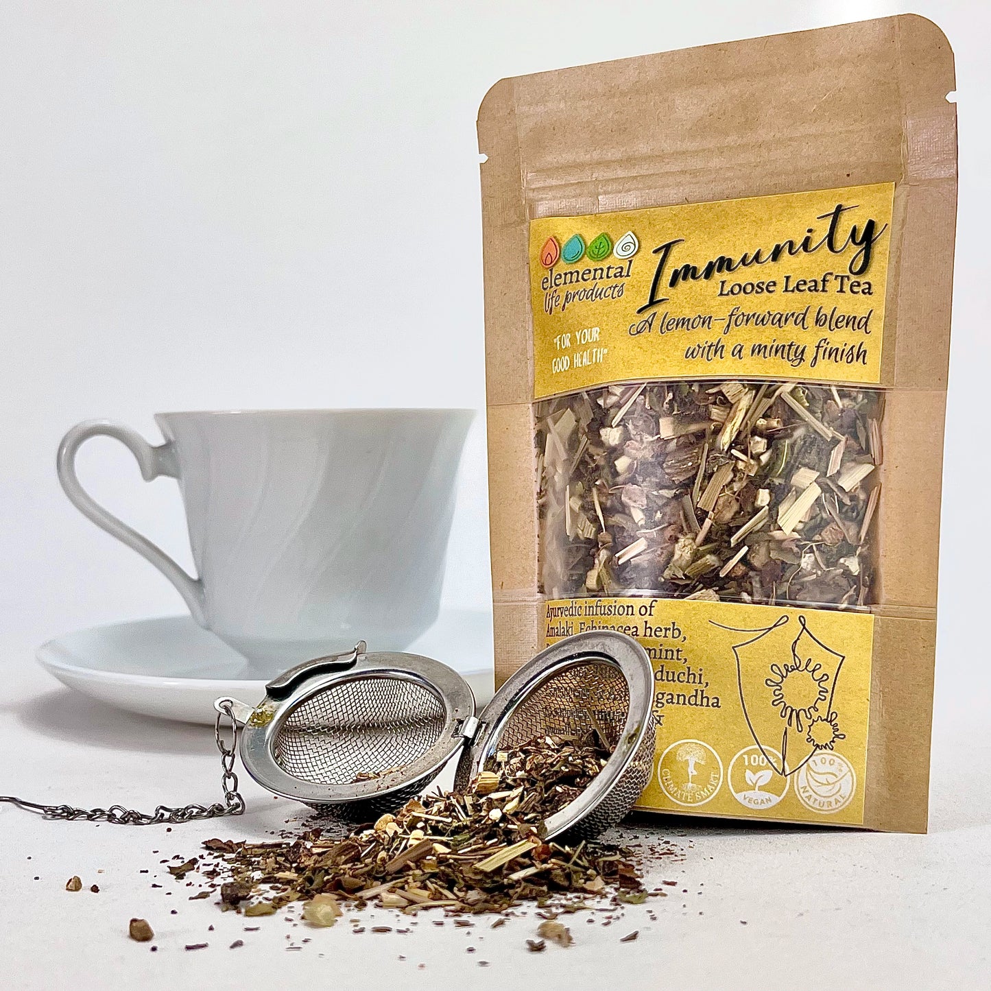 Elemental Life Product's Immunity loose leaf tea blend with Amalaki, Echinacea herb, and Burdock with a tea ball and tea cup