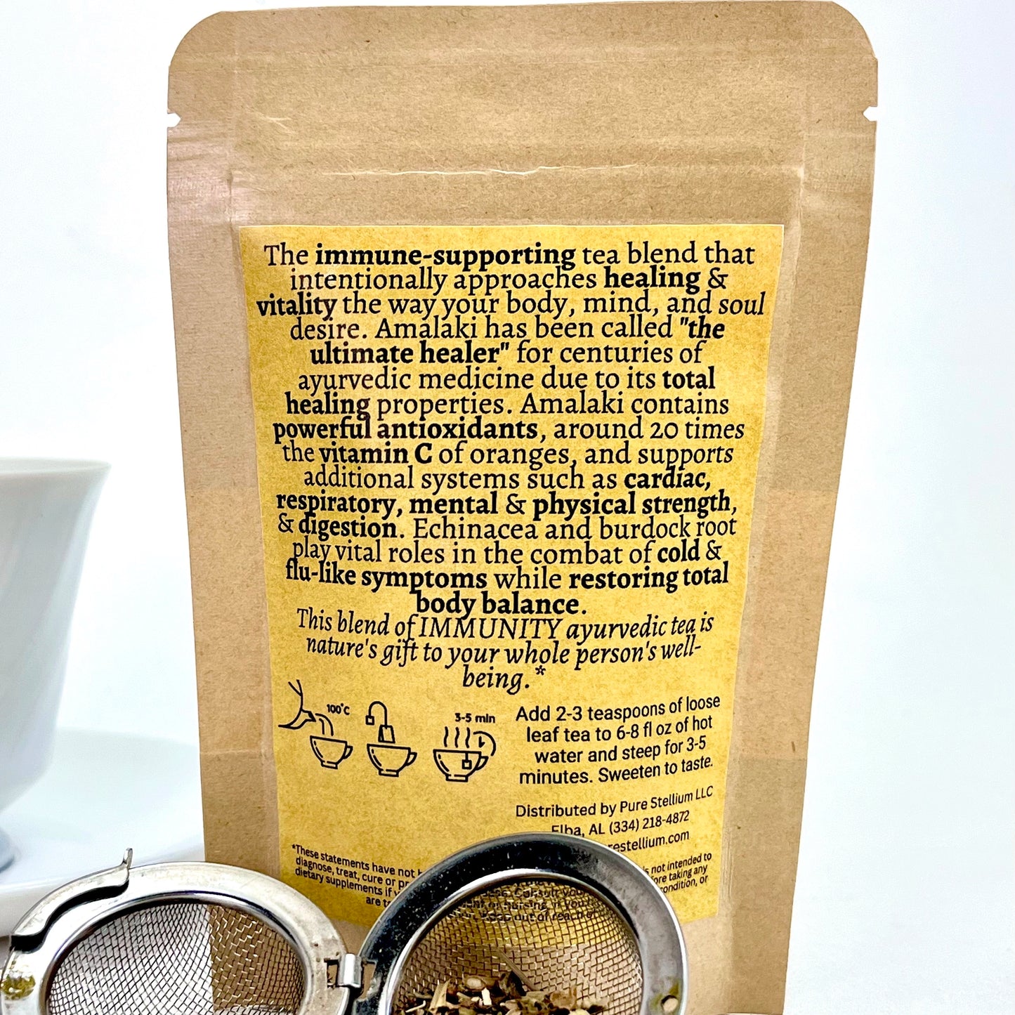 The package of Elemental Life Product's Immunity loose leaf tea blend with raw ingredients in open tea ball
