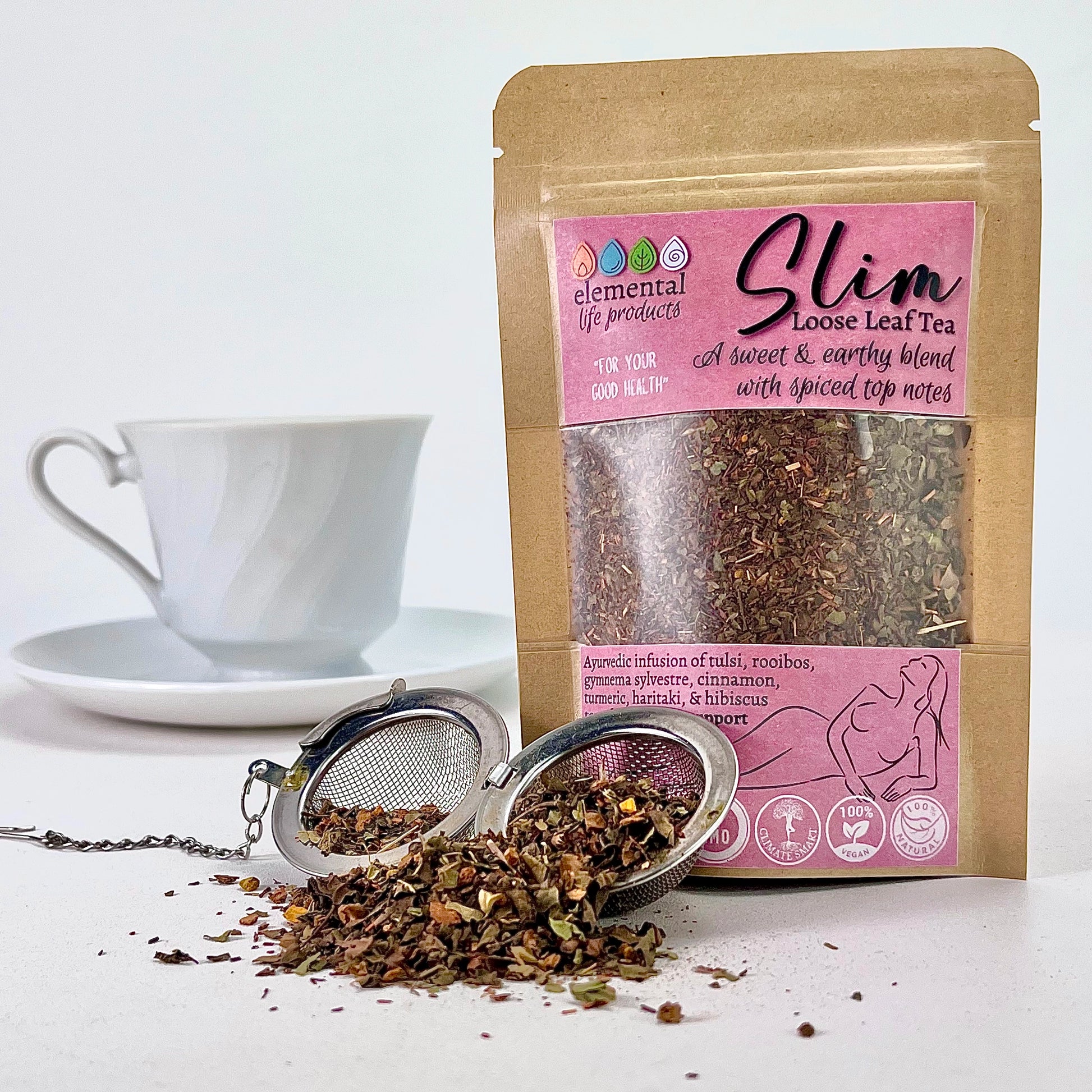 Elemental Life Product's Slim Loose Leaf tea with tulsi, rooibos, and gymnema sylvestre with a tea ball and tea cup.