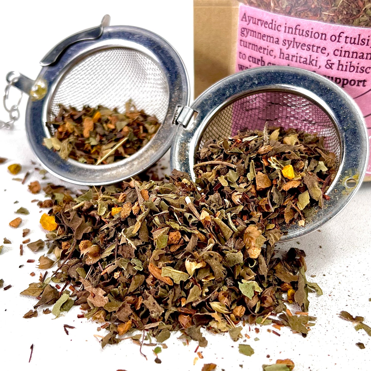 Loose leaf tea with ingredients tulsi, rooibos, gymnema sylvestre, cinnamon,  turmeric, haritaki, & hibiscus in a tea ball.